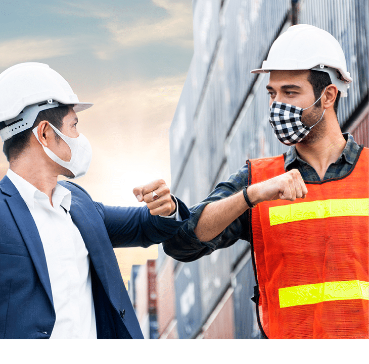 construction site worker and foreman wearing hygiene face mask elbow bump greeting in New Normal adaptation to prevent Coronavirus or Covid-19 spreading  social distance working style at warehouse