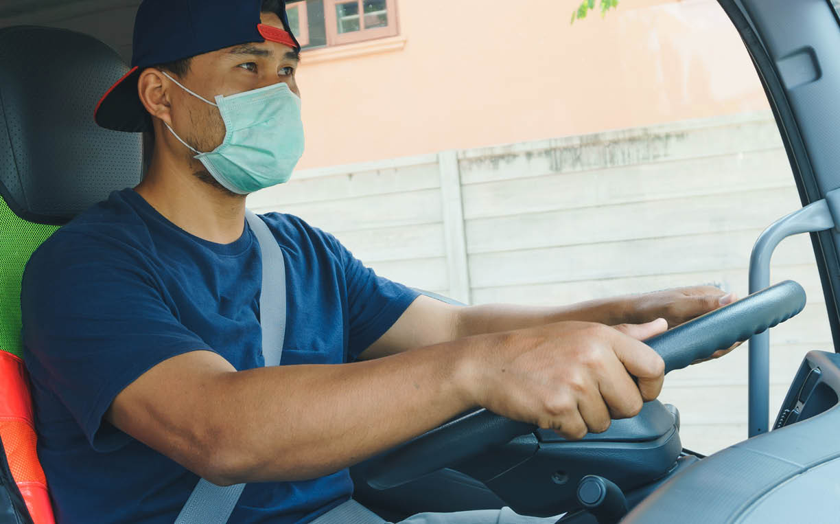 Photos of Asian truck drivers wearing masks to protect against dust and the spread of COVID 19 in front of the car  Safety ideas for a worker in the transportation business  And is a new normal life 
