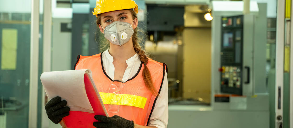 Female Mechanic wearing  protective mask to Protect Against Covid-19,Female technician worker working and checking machine in a large industrial factory,Coronavirus has turned into a global emergency