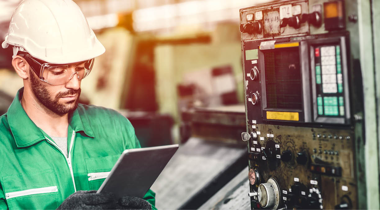 Green eco worker checking energy consumption engieer working in heavy industry factory with green colour safety suit 