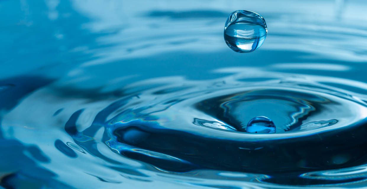 water drop splash in a glass blue colored