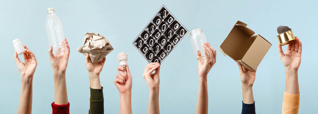 Separate collection of garbage  Human hands holding plastic, glass, metal, paper, lightbulb stuff for recycle  Eco friendly people  Human's hand holds recyclable waste on blue background  Zero waste