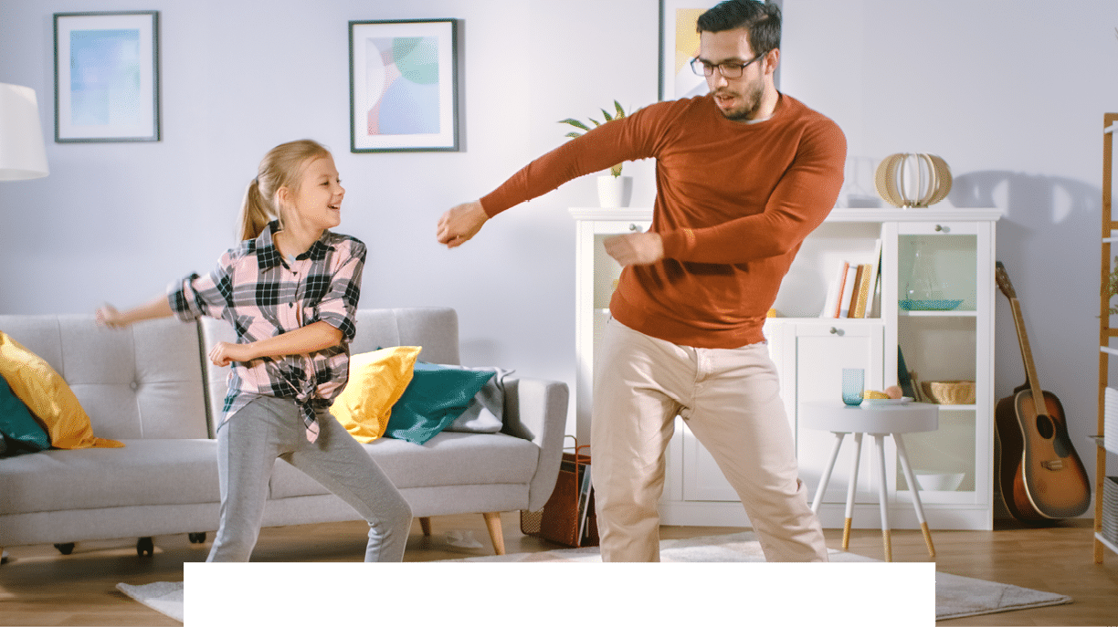 Happy Little Girl Dances with Young Father in the Middle of the Living Room  Happy Family Time, Father and Daughter Dancing at Home 