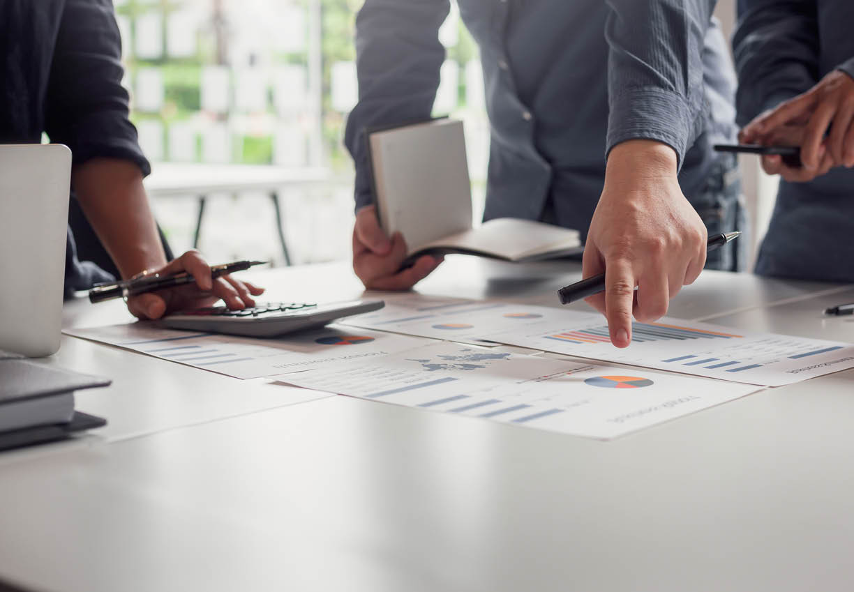 Group of business people meeting together Pointing to the graph assess business profits 