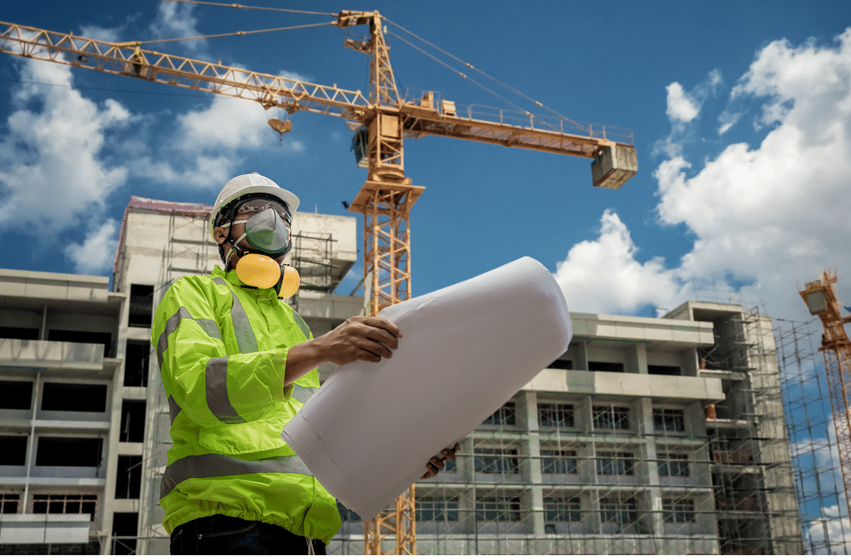 Civil Engineering people wearing face mask and safety helmet on construction site holding blueprint in his hand  Building inspector  Construction site check drawing and business workflow of building