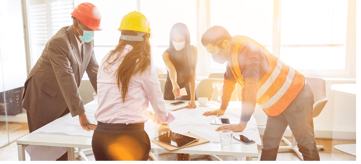 Architects teamwork in the office with face mask because of Covid-19 and corona virus